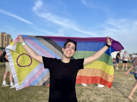 International student Marta holding the pride flag