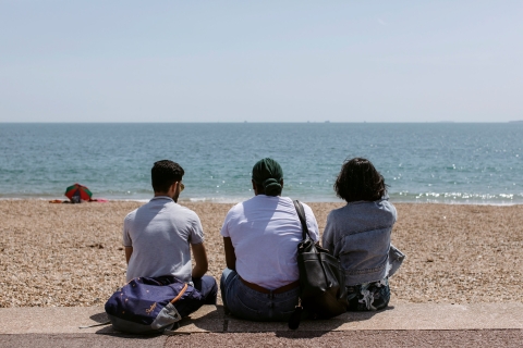 Students sat on southsea beach staring out to see
