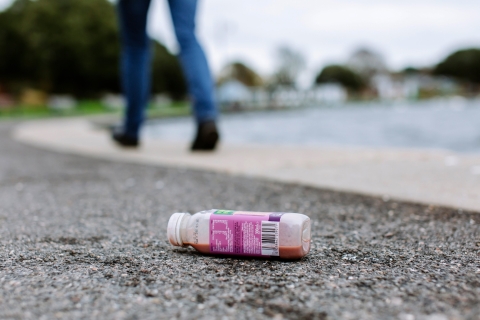 an empty plastic juice bottle, discarded by the roadside