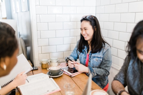 Postgraduate students working and laughing