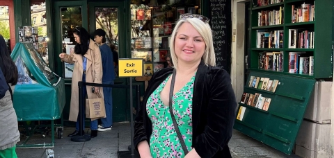 Photo of Sarah Groszewski standing outside a bookshop