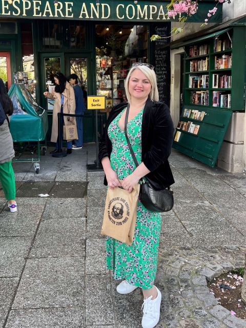 Photo of Sarah Groszewski standing outside a bookshop