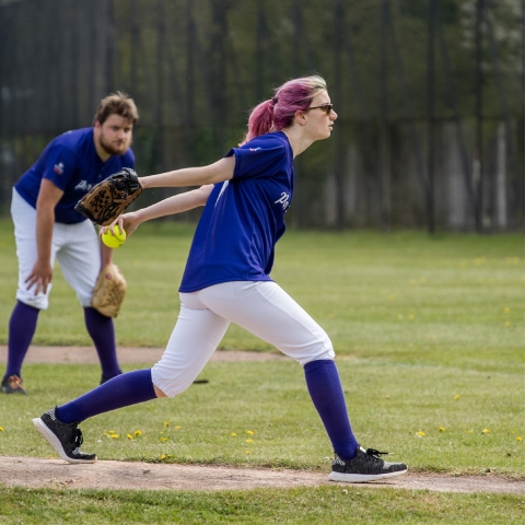 Girl pitching while playing softball