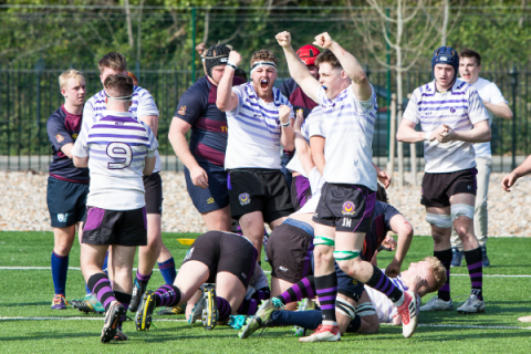 Rugby players celebrating after scoring