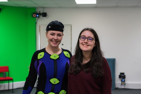 Alanna Charlton poses with person in motion capture suit
