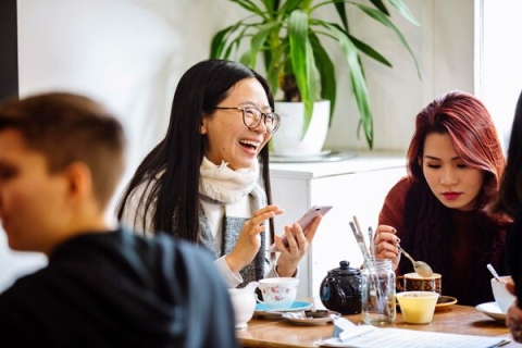 students sat drinking coffee laughing