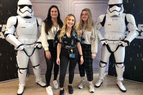 Media Studies student Jess Woodford standing with Disney coworkers at Star Wars event