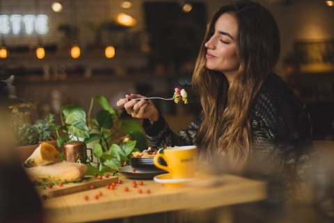 Woman eating from a plate of food