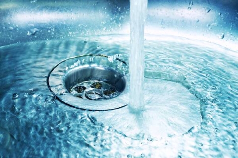 stream of water running down a plug hole