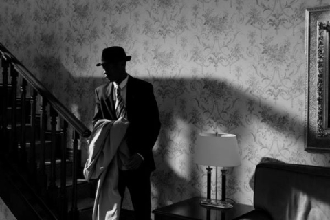 male actor posing in an old house