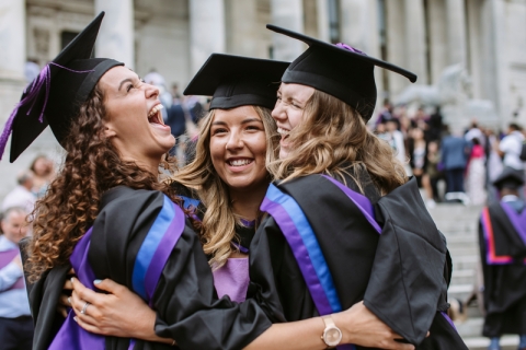 3 female graduates in their robes