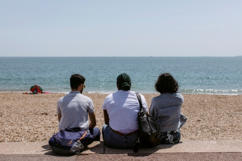  Students sat on southsea beach staring out to see