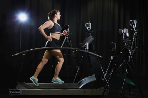 Female runner on treadmill with motion capture cameras
