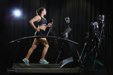 Female runner on treadmill with motion capture cameras 