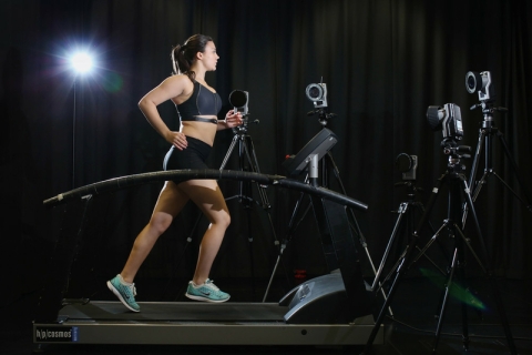 Female runner on treadmill with motion capture cameras