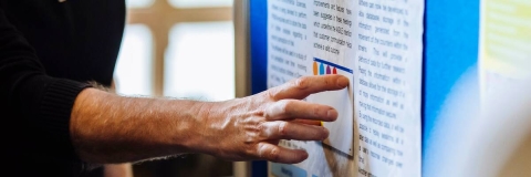 hand pointing to poster