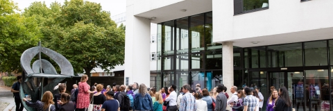 Photo of attendees gathered outside the Dennis Sciama CafeAlumni Weekend
