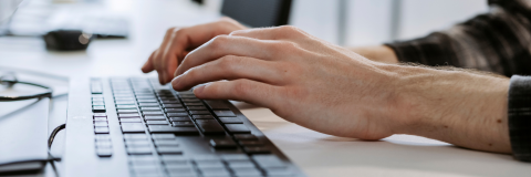 hands typing at a keyboard