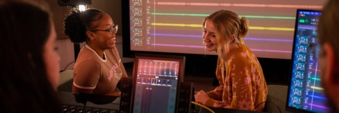 Two students sitting in a recording studio