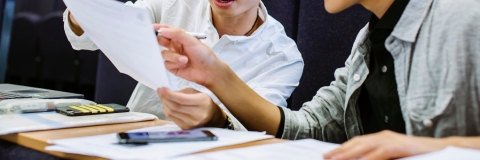 Students discussing notes in pre-sessional English session