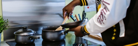 A student using a university halls kitchen