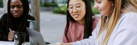 Three students studying on Laptop in Eldon centre outdoor space