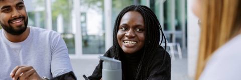 Three students working together with Laptop and Books in Eldon seating area