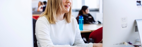 Female student using computer in Eldon suite