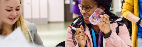 Young women painting glassware