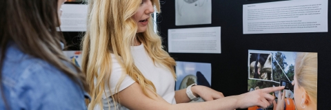 Photo of Laura Saunders presenting information at stall.- Festival of Doctoral ResearchFOR GRADUATE SCHOOL USE ONLY