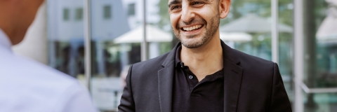 Photo of Charlie Pericleous smiling and talking outside- Festival of Doctoral ResearchNOT FOR THIRD PARTY CONSENTFOR GRADUATE SCHOOL USE ONLY