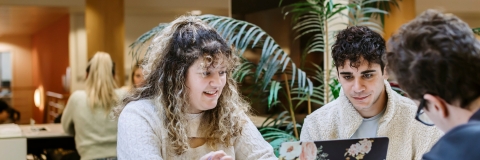 Three students conversing in a study space