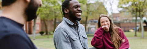Three students sat on bench relaxing