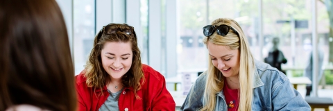 Two female students smiling and having fun