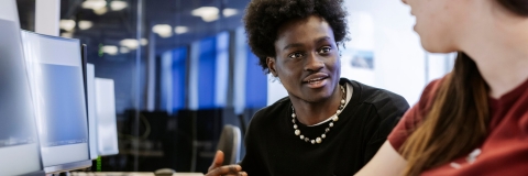 Students talking whilst sat at computer desksTechnology Facilities Day One - NOT FOR THIRD PARTY - CONSENT