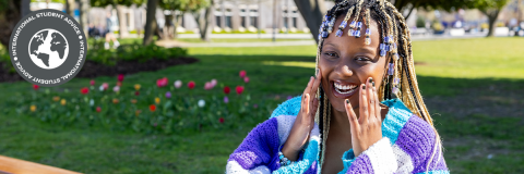 International Student Advice hero image of a student sitting on a bench in a park