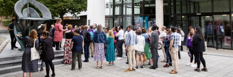 Photo of attendees gathered outside the Dennis Sciama CafeAlumni Weekend