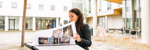 Female student looking over project in Eldon Courtyard