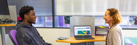 A student speaking to a careers adviser