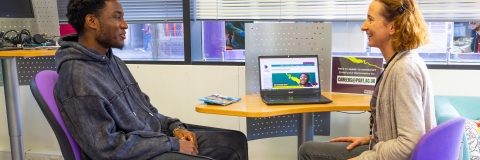 A student speaking to a careers adviser