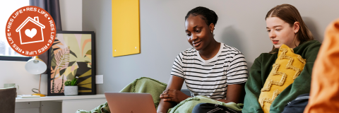 Res Life hero image showing two students in a halls bedroom looking at a laptop