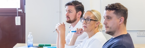 Three University of Portsmouth students sitting at a table
