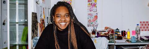 University of Portsmouth student smiling in an art studio