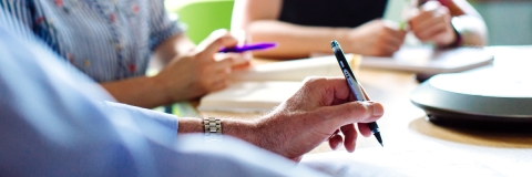 Staff member holding a pen