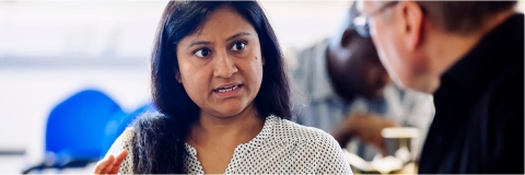 Female PhD student speaking in coffee shop