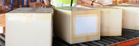 Worker moving boxes in a storage warehouse