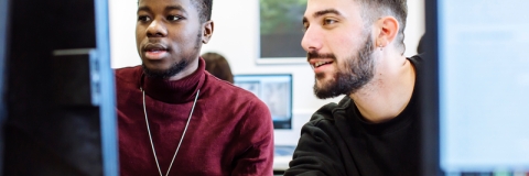 2 male students in front of computers