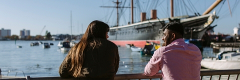 Female and male student looking towards the harbour
