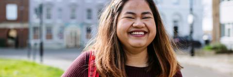 Smiling female student at University of Portsmouth building