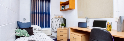 Bedroom in Bateson student halls with a bed, desk and chair